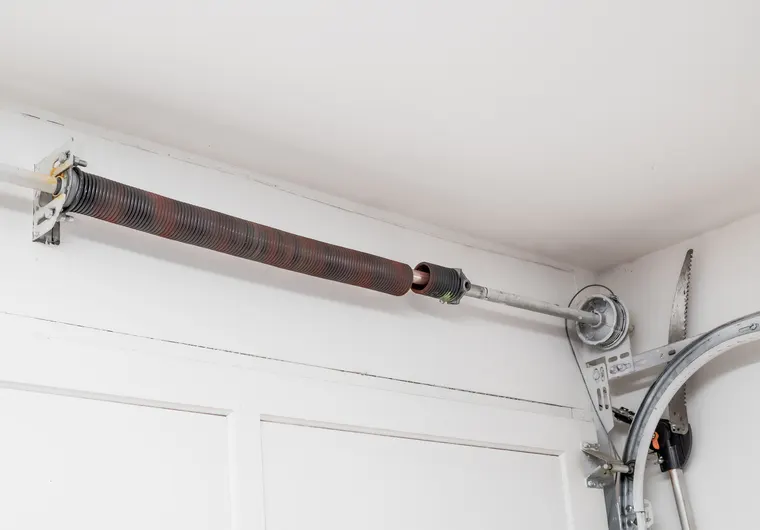 Emergency garage door repair for a broken torsion spring after hours