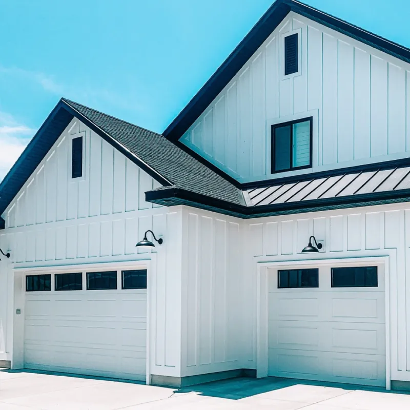 White farmhouse-style garage doors with windows