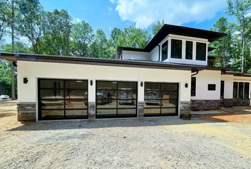 Modern glass panel garage doors on contemporary home